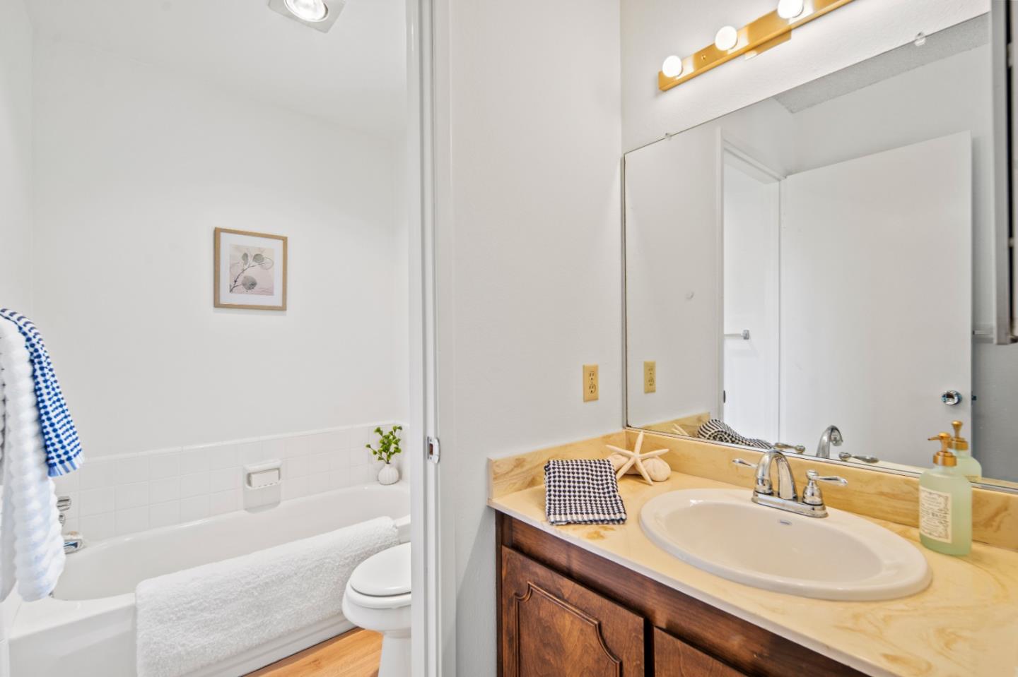 70 Forest Ridge Road, Unit 22 Monterey, CA 93940 - Photo 11 of 17 a bathroom with a granite countertop sink toilet and shower