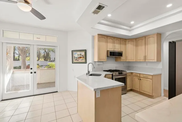 a kitchen with stainless steel appliances granite countertop a stove and a refrigerator