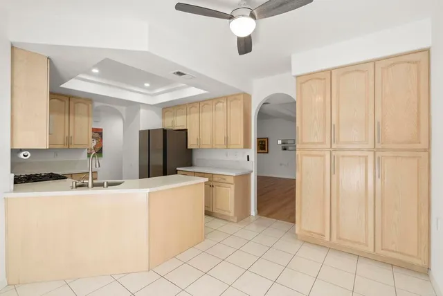 a kitchen with stainless steel appliances granite countertop a refrigerator and a sink