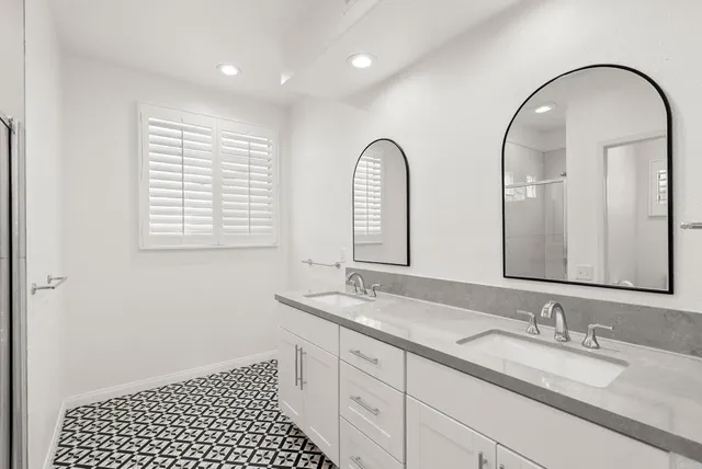 a bathroom with a granite countertop sink a mirror and a