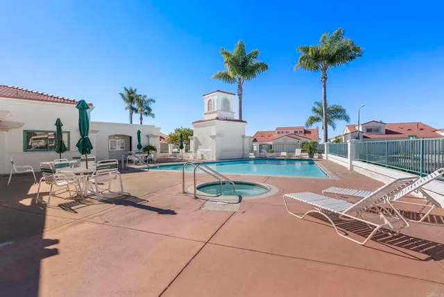 a view of a house with pool yard and sitting area