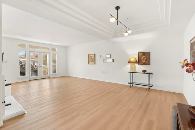 a view of a livingroom with wooden floor and a ceiling fan