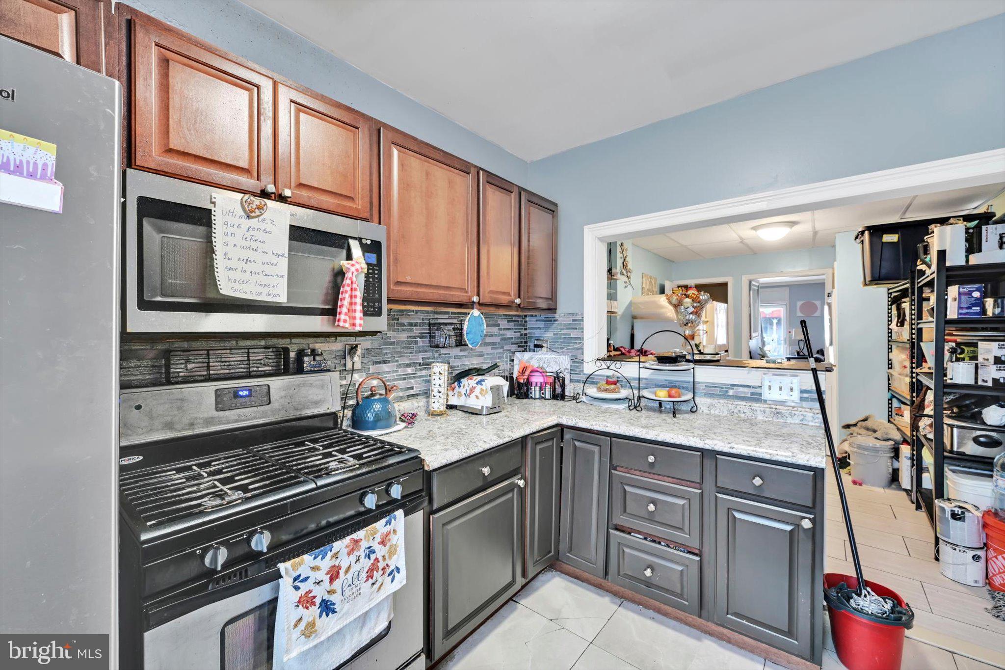 352 South Ann Street Lancaster, PA 17602 - Photo 10 of 23 a kitchen with stainless steel appliances granite countertop a stove top oven a sink dishwasher and cabinets with wooden floor