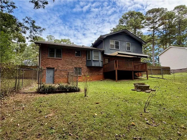 a backyard of a house with table and chairs
