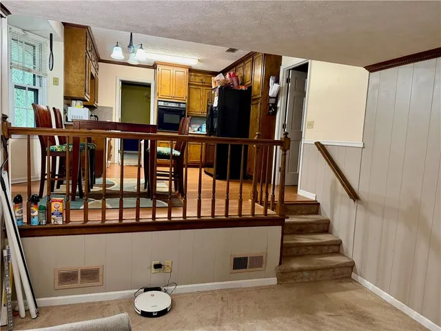 a kitchen with stainless steel appliances wooden cabinets and a sink