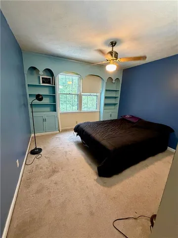 a bedroom with furniture and a window