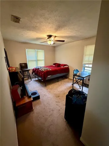 a bedroom with a bed and a couch