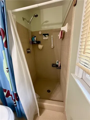 a bathroom with a sink mirror and toilet