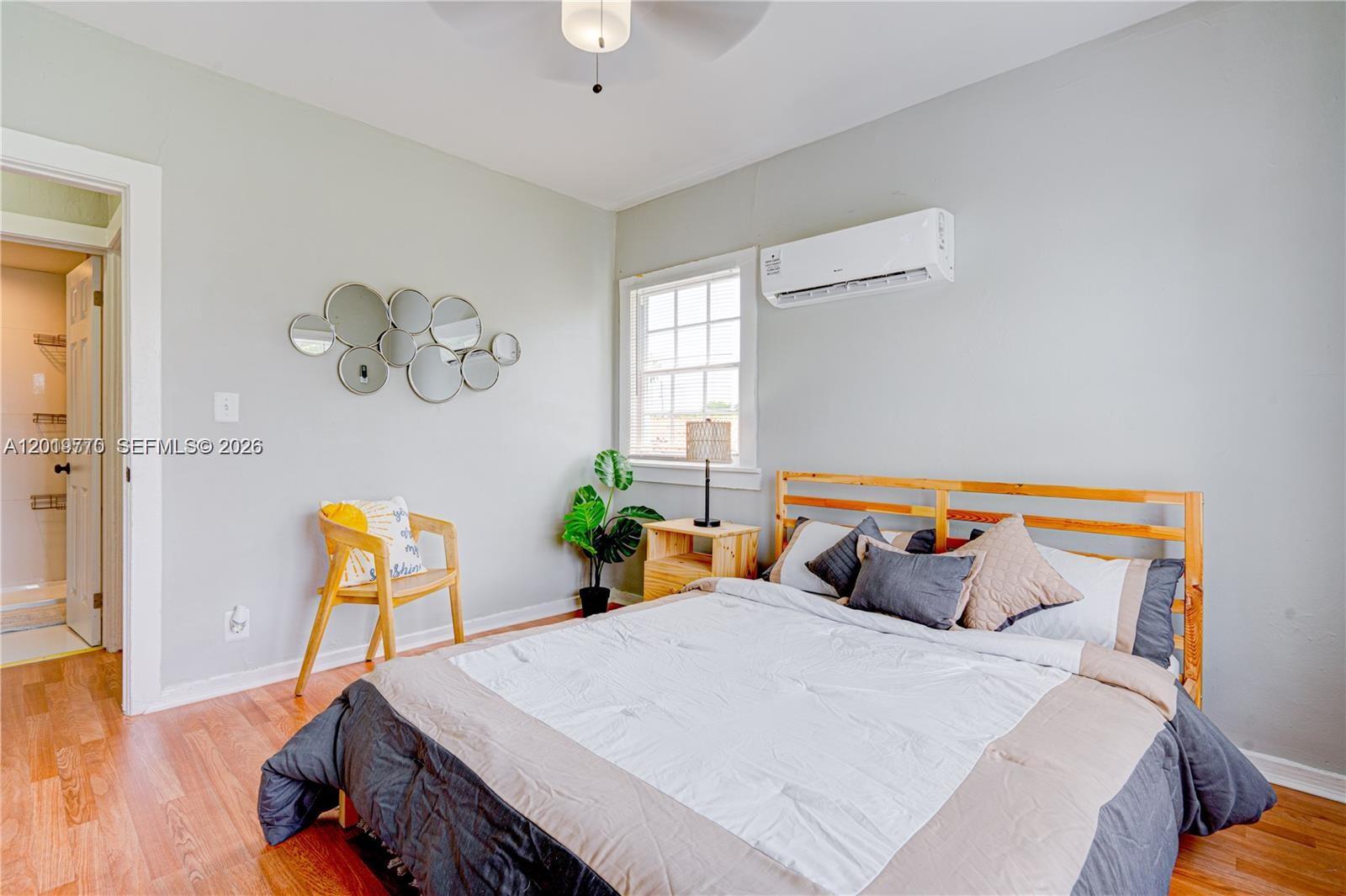 227 Southwest 30th Avenue, Unit B Miami, FL 33135 - Photo 9 of 15 a bedroom with a bed and a table in it