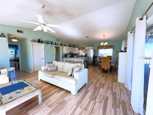 a living room with furniture a flat screen tv and a large window