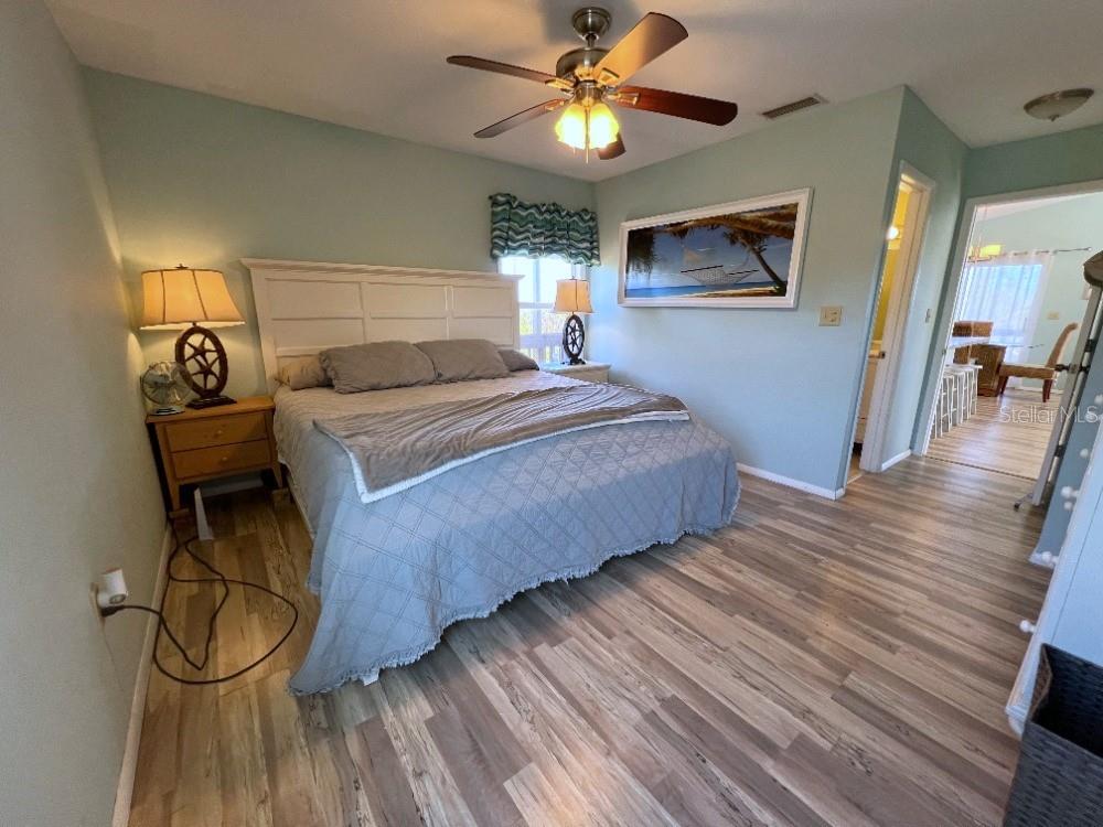 9526 Jolly Roger Trail Placida, FL 33946 - Photo 16 of 54 a bedroom with a bed and a chandelier