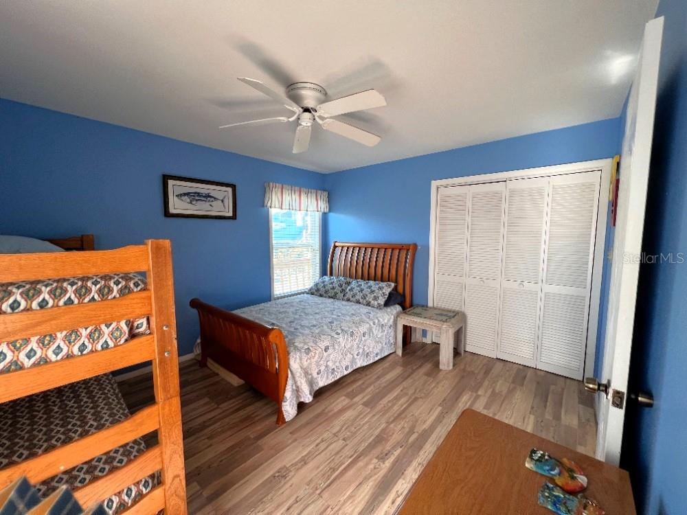 9526 Jolly Roger Trail Placida, FL 33946 - Photo 19 of 54 a bedroom with a bed and wooden floor