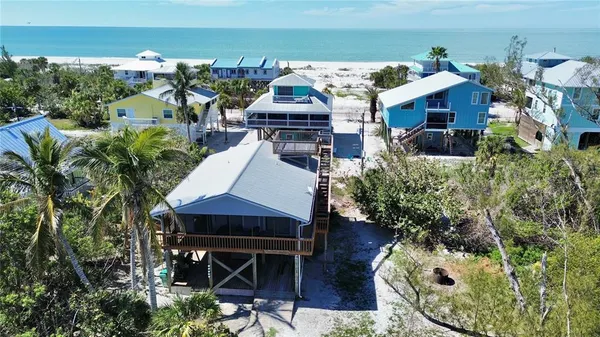 an aerial view of a house with swimming pool and patio