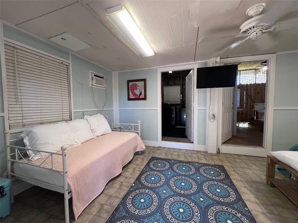 9526 Jolly Roger Trail Placida, FL 33946 - Photo 31 of 54 a bedroom with a large bed a flat tv screen and a dresser