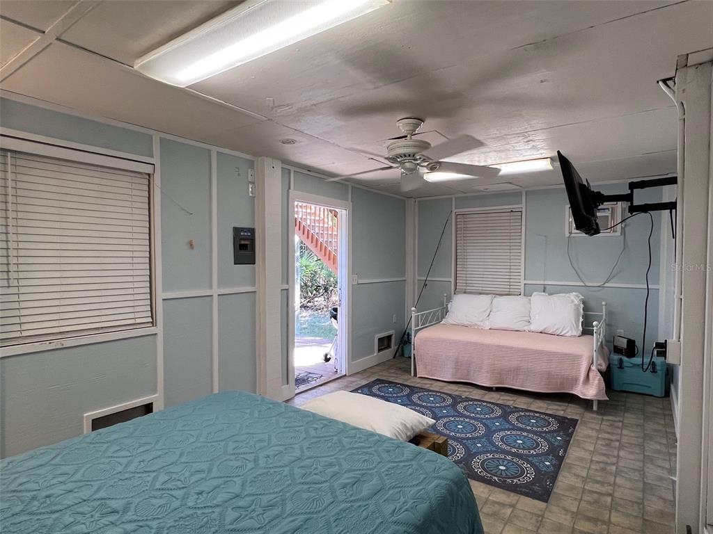 9526 Jolly Roger Trail Placida, FL 33946 - Photo 35 of 54 a bedroom with a bed mirror and window