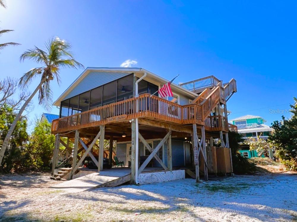 9526 Jolly Roger Trail Placida, FL 33946 - Photo 36 of 54 a view of a chairs and table in a backyard