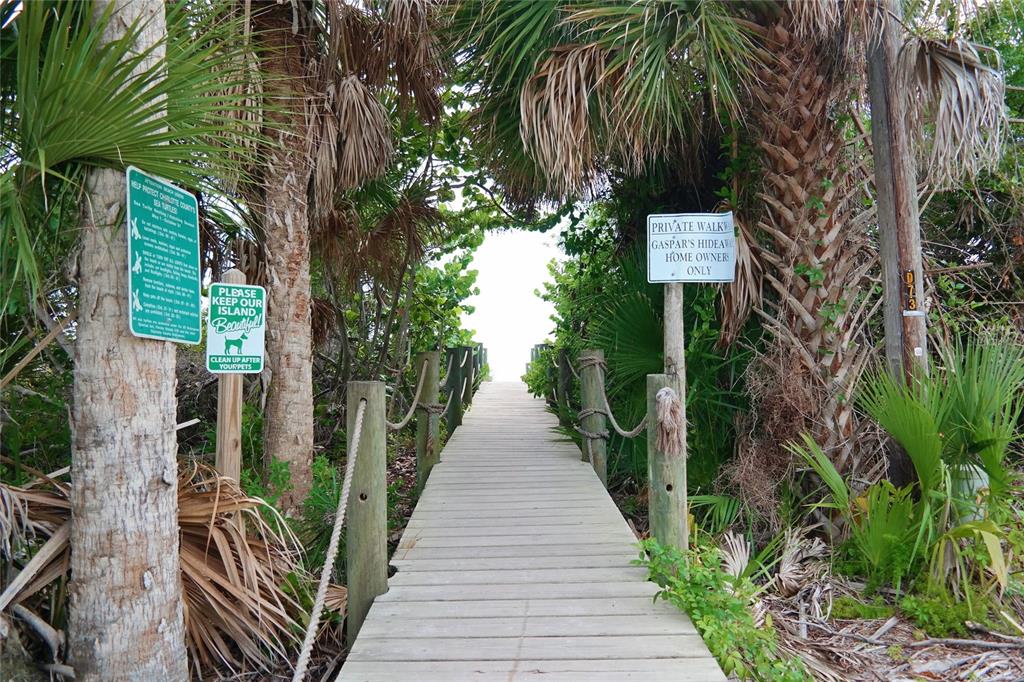 9526 Jolly Roger Trail Placida, FL 33946 - Photo 40 of 54 a view of a pathway of a house with wooden fence