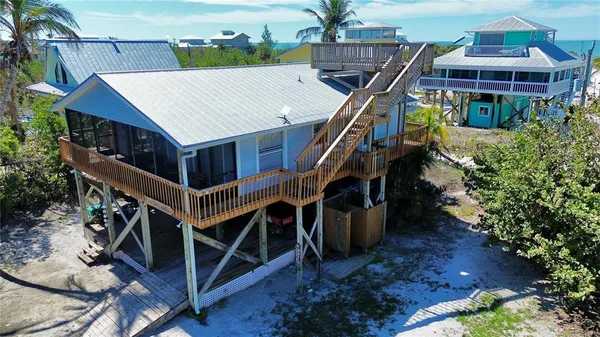 a view of a house with a yard and a deck