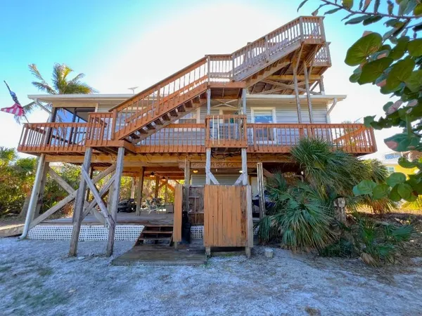 a view of balcony with wooden floor and fence