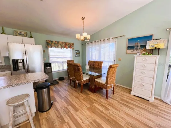 a living room with kitchen island furniture and a chandelier
