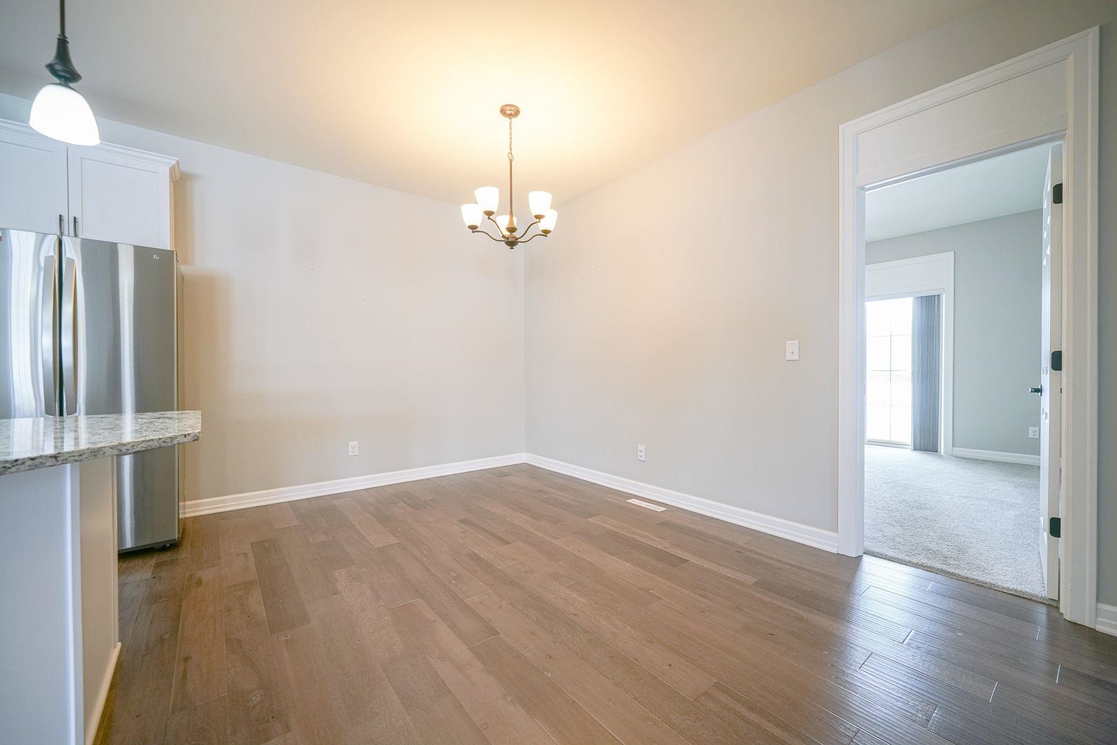 212 Martin Avenue Oregon, IL 61061 - Photo 12 of 29 wooden floor in an empty room with a window