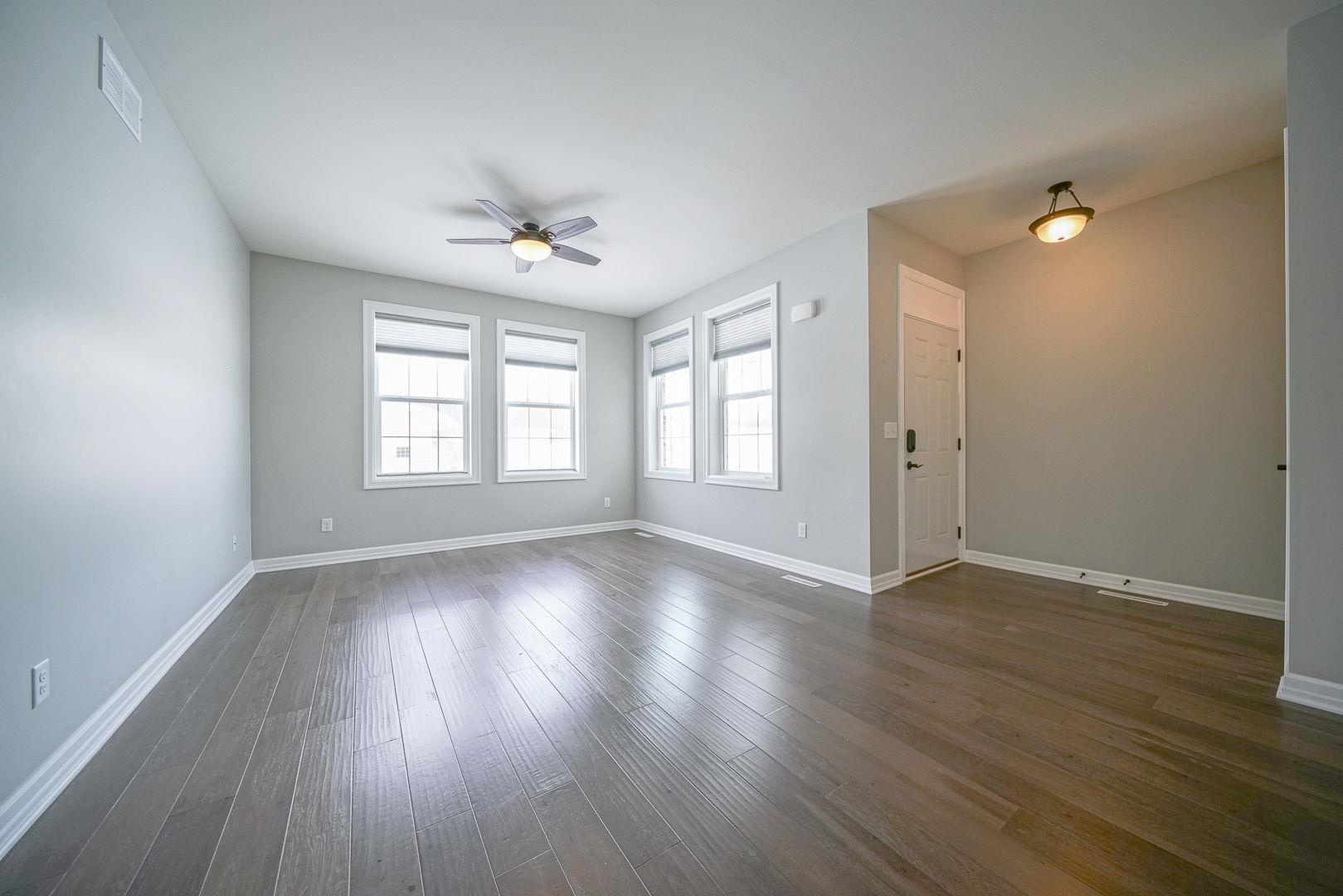 212 Martin Avenue Oregon, IL 61061 - Photo 3 of 29 an empty room with wooden floor and windows