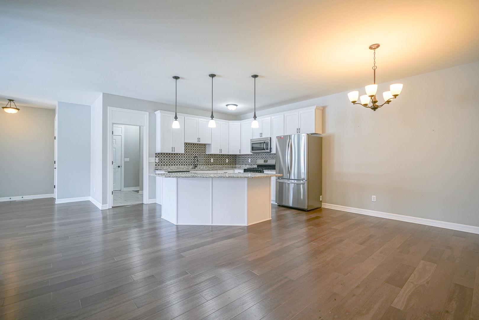 212 Martin Avenue Oregon, IL 61061 - Photo 5 of 29 a large kitchen with granite countertop a large counter top stainless steel appliances and cabinets