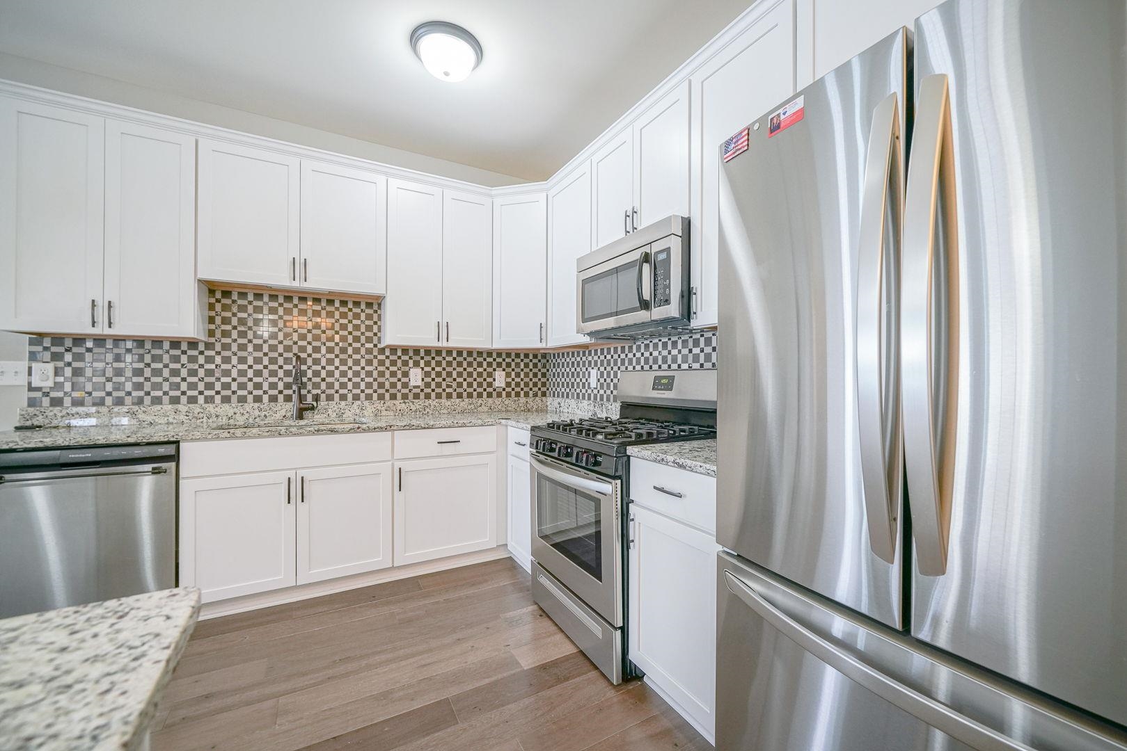 212 Martin Avenue Oregon, IL 61061 - Photo 6 of 29 a kitchen with stainless steel appliances granite countertop a refrigerator sink and stove