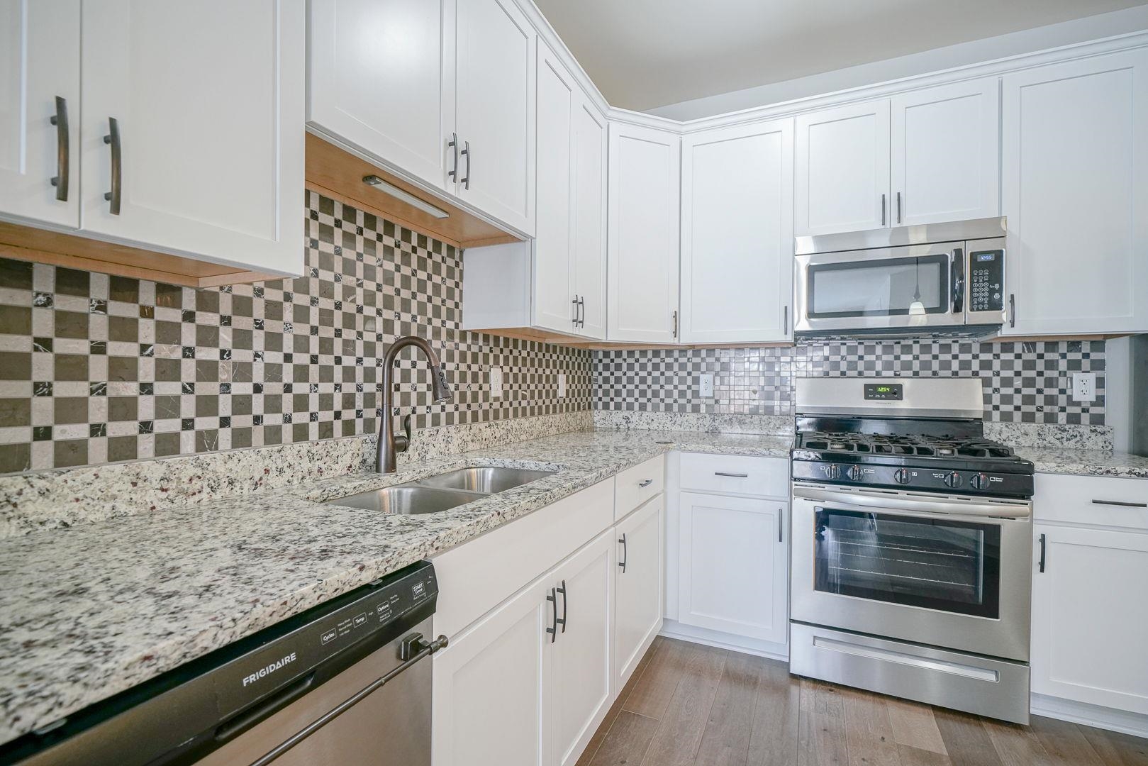 212 Martin Avenue Oregon, IL 61061 - Photo 7 of 29 a kitchen with a sink stove and cabinets