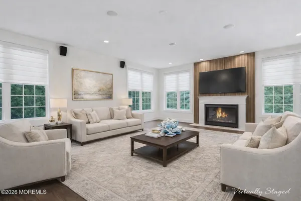 a living room with furniture a fireplace and a flat screen tv