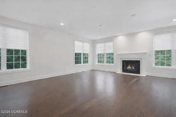 an empty room with wooden floor and a window