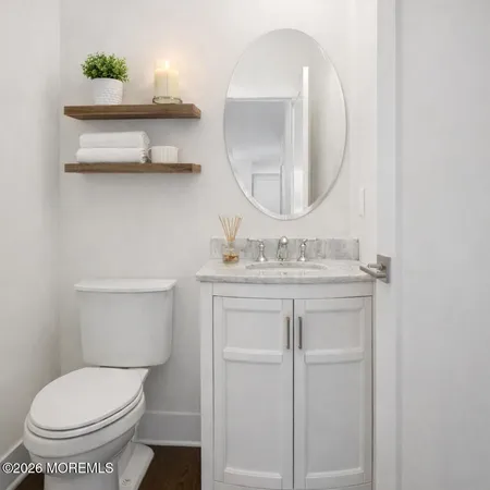 a bathroom with a toilet a sink and mirror