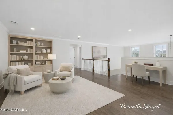 a living room with furniture and a book shelf