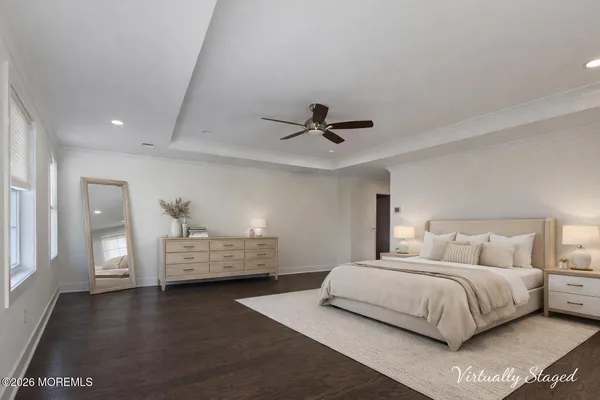 a bedroom with a bed and ceiling fan