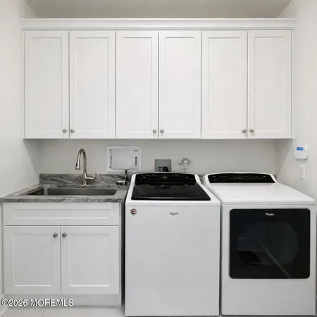 a kitchen with granite countertop white cabinets and white appliances