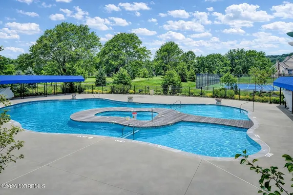 a view of a swimming pool with an outdoor seating and a yard