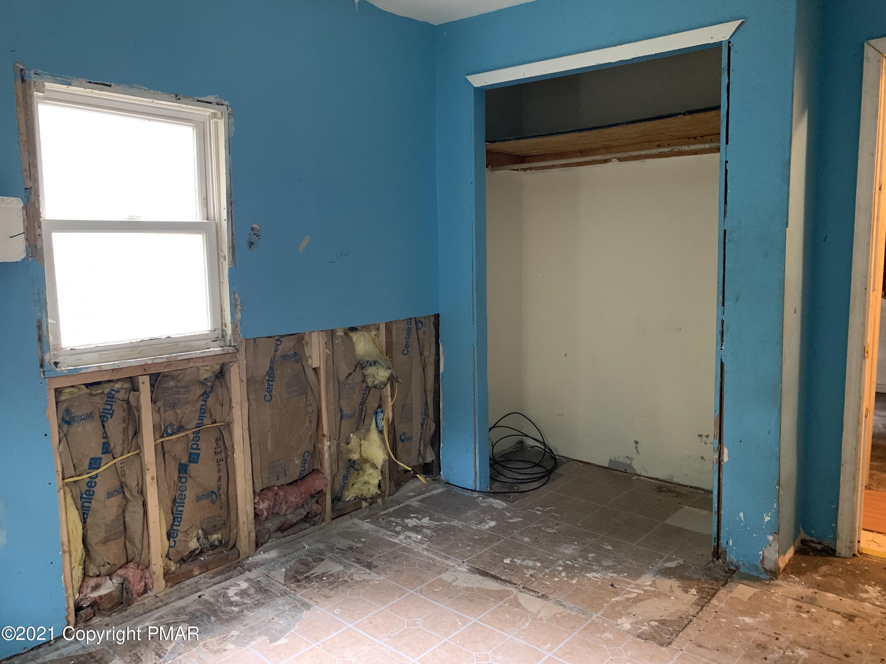 203 Semmel Road Effort, PA 18330 - Photo 14 of 18 a view of a room that has a large window and storage space