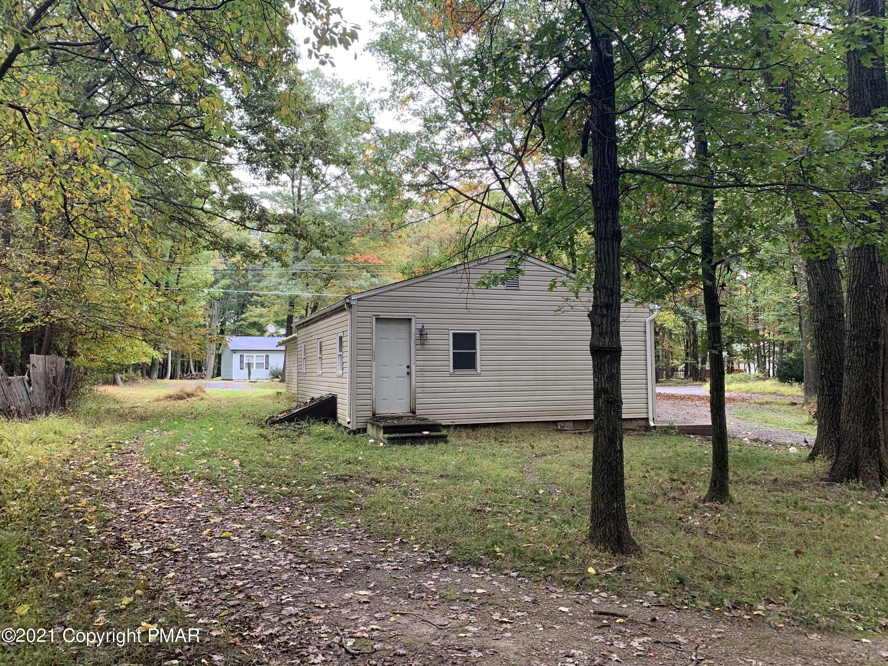 203 Semmel Road Effort, PA 18330 - Photo 3 of 18 a house is sitting in middle of the forest