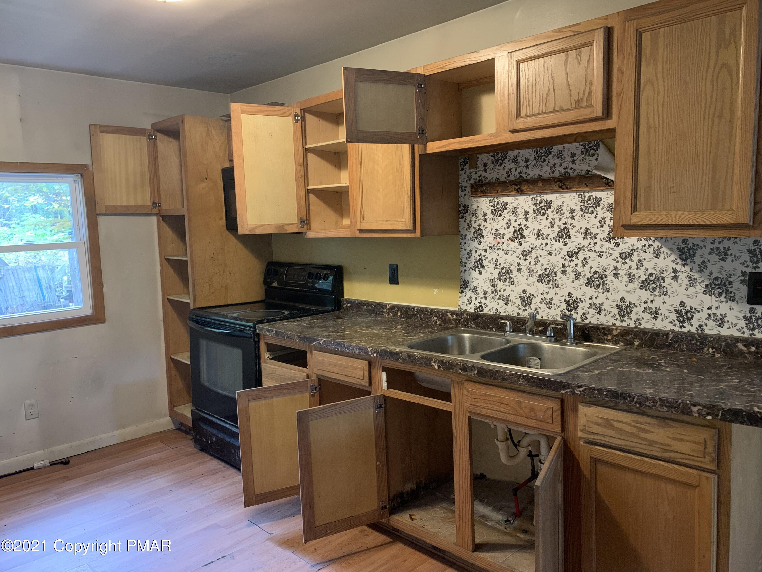 203 Semmel Road Effort, PA 18330 - Photo 7 of 18 a kitchen with stainless steel appliances granite countertop a stove a sink and a microwave