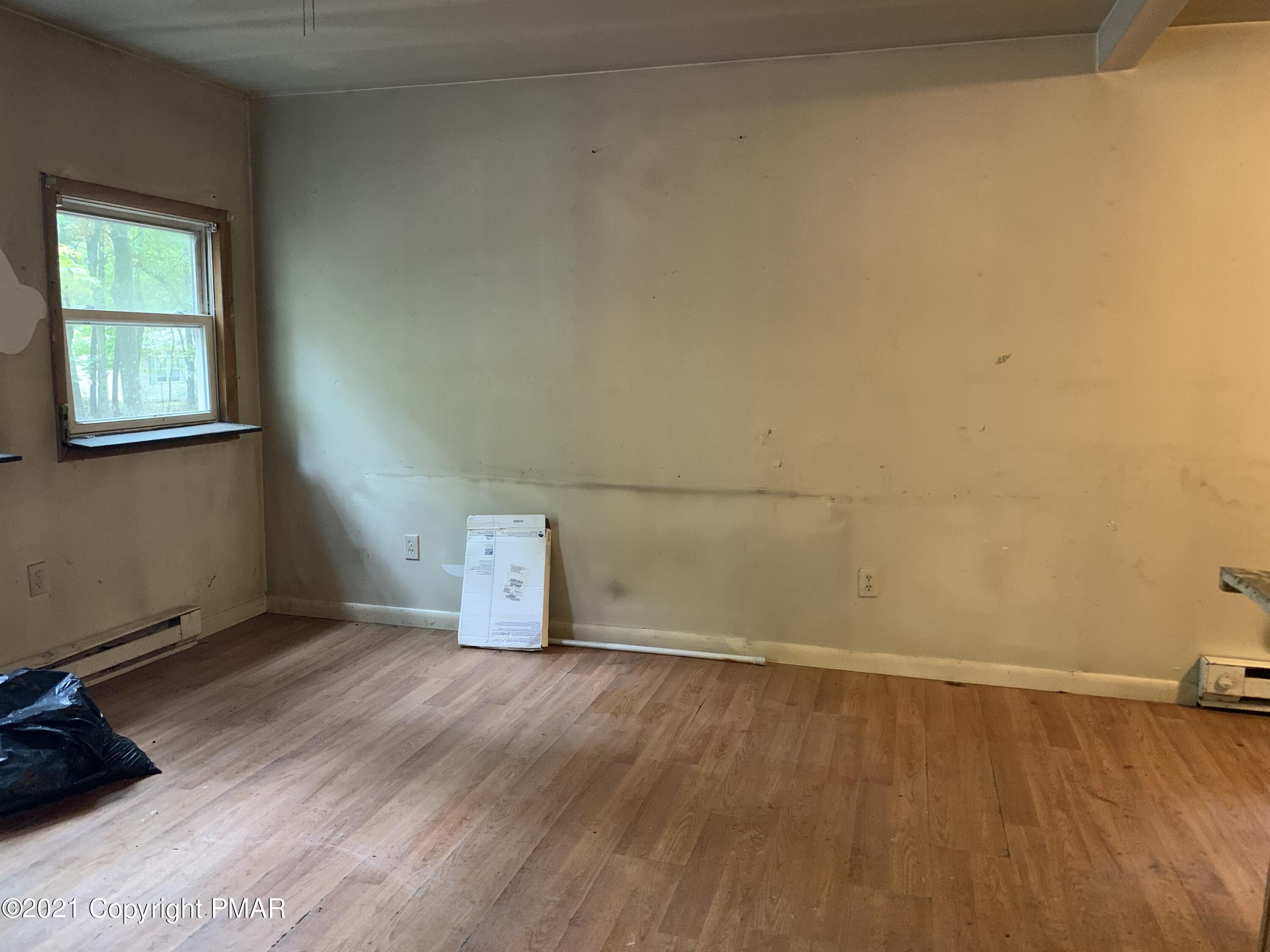 203 Semmel Road Effort, PA 18330 - Photo 10 of 18 an empty room with wooden floor and windows