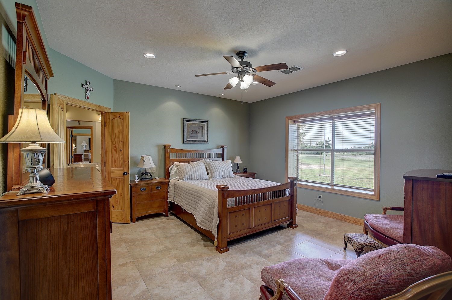 9414 Laird Road Round Top, TX 78954 - Photo 33 of 50 Primary bedroom with tiled flooring and lots of light with plenty of room for the seating area/reading nook