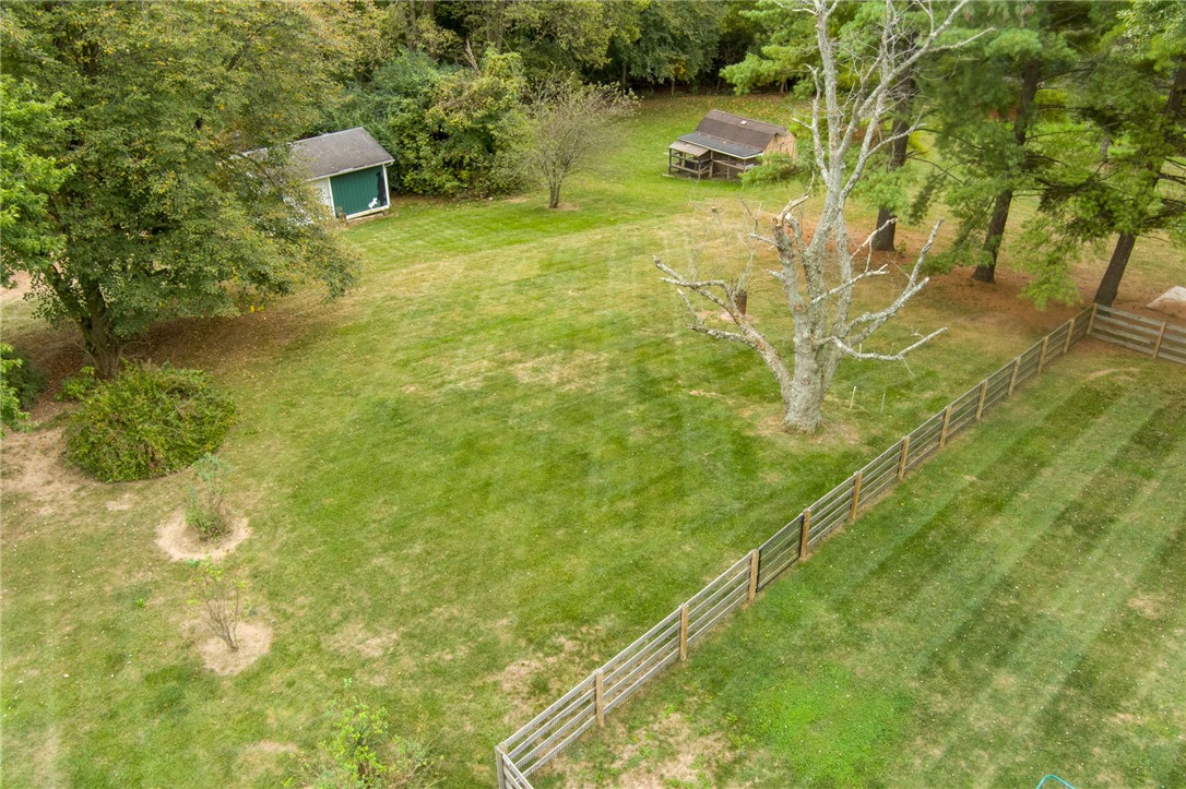 6950 Red Lion 5 Points Road Springboro, OH 45066 - Photo 71 of 78 Expansive green yard with mature trees and a rustic fence defines this property's natural charm.
