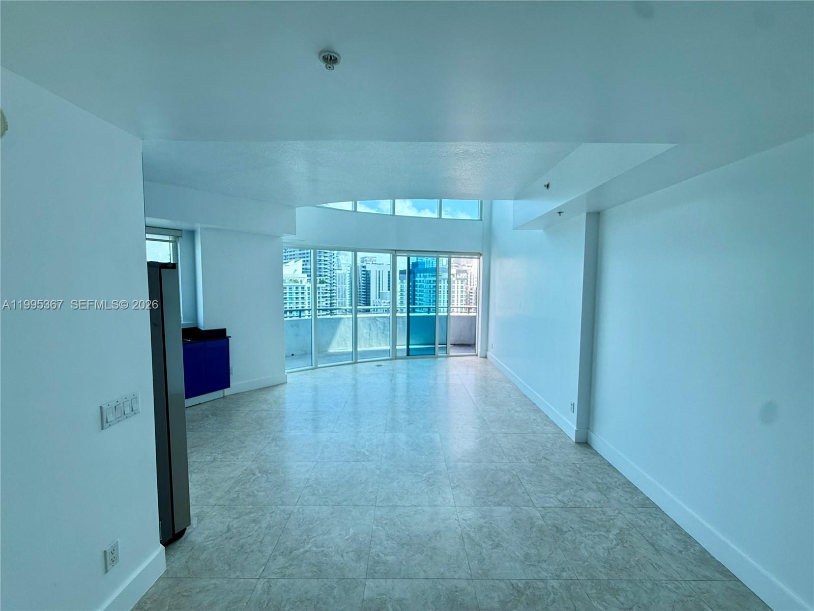 60 Southwest 13th Street, Unit 4018 Miami, FL 33130 - Photo 2 of 26 wooden floor in an empty room with a window