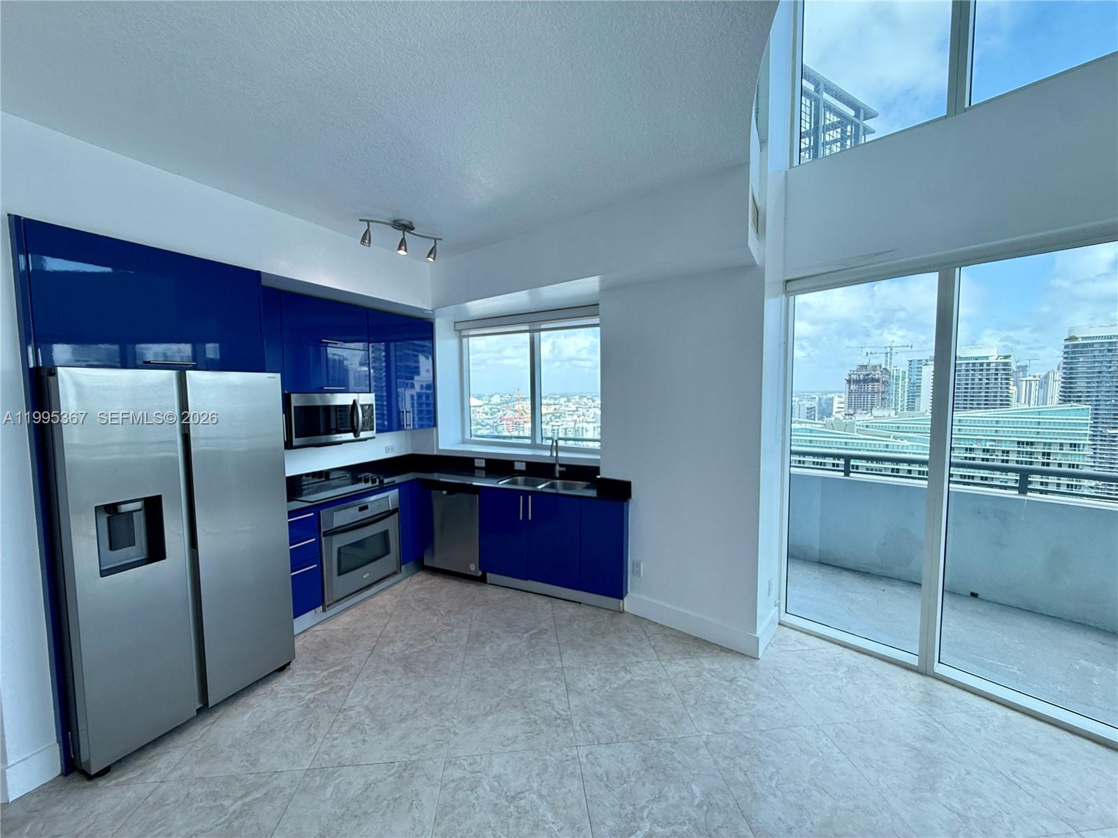 60 Southwest 13th Street, Unit 4018 Miami, FL 33130 - Photo 3 of 26 a kitchen with stainless steel appliances granite countertop a refrigerator and a sink