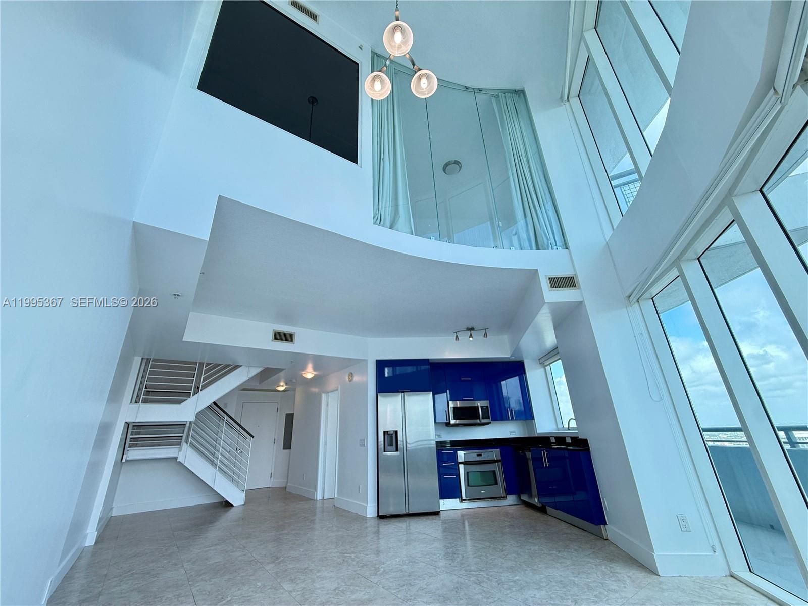 60 Southwest 13th Street, Unit 4018 Miami, FL 33130 - Photo 4 of 26 a view of a livingroom with wooden floor