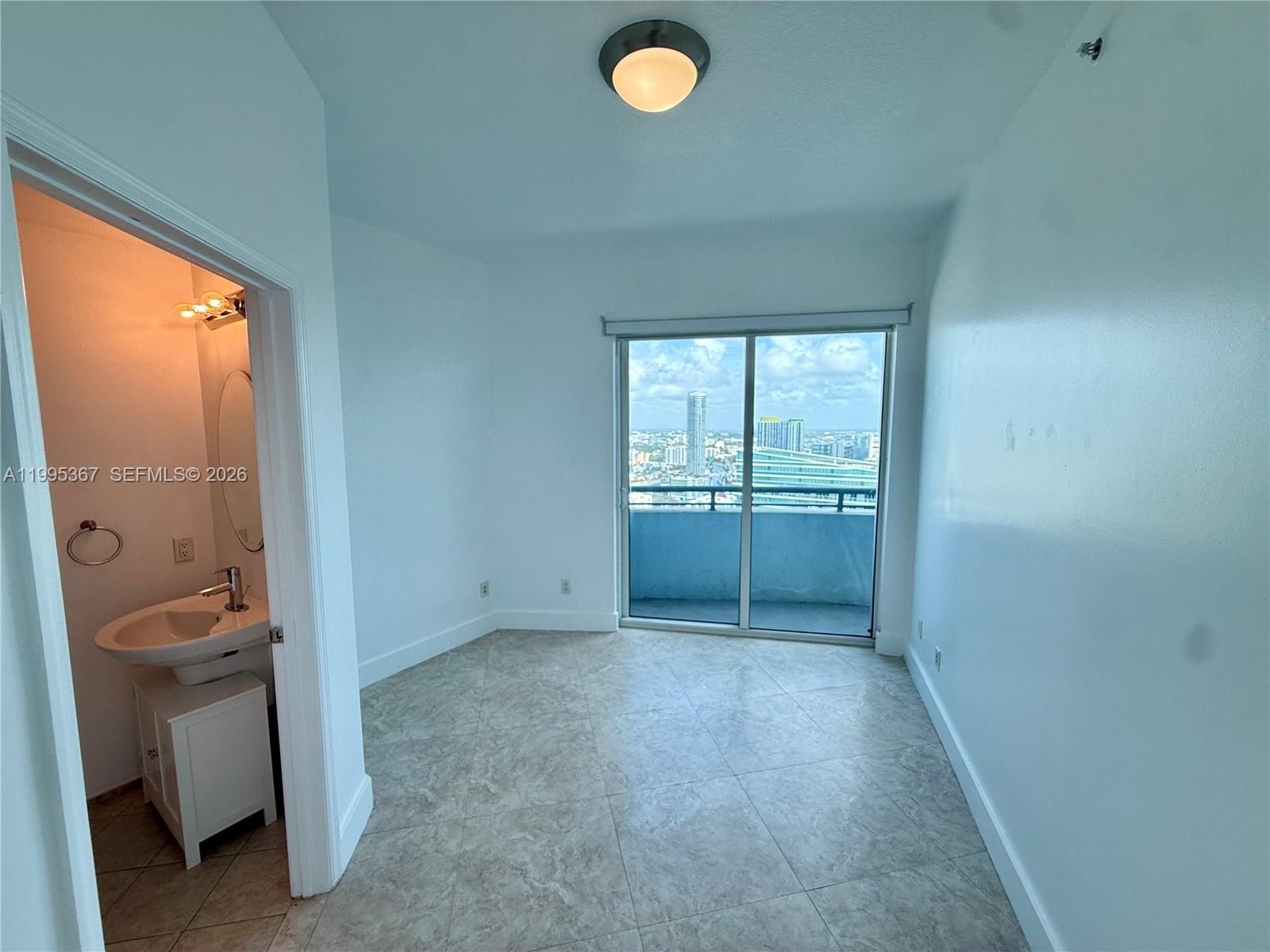 60 Southwest 13th Street, Unit 4018 Miami, FL 33130 - Photo 7 of 26 an empty room with windows and closet