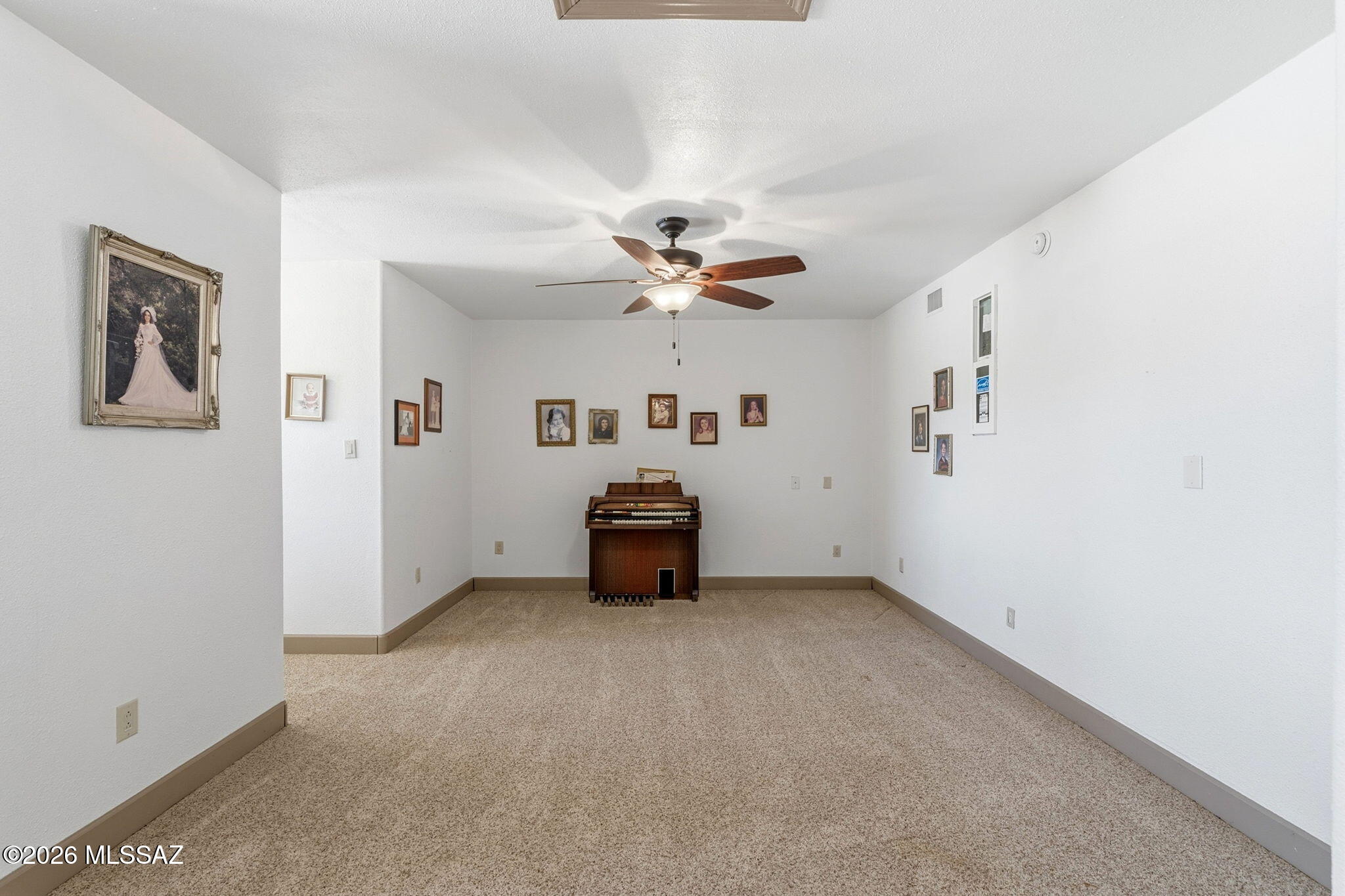 12810 West Gunsmoke Road Tucson, AZ 85736 - Photo 30 of 51 an empty room with a ceiling fan and window