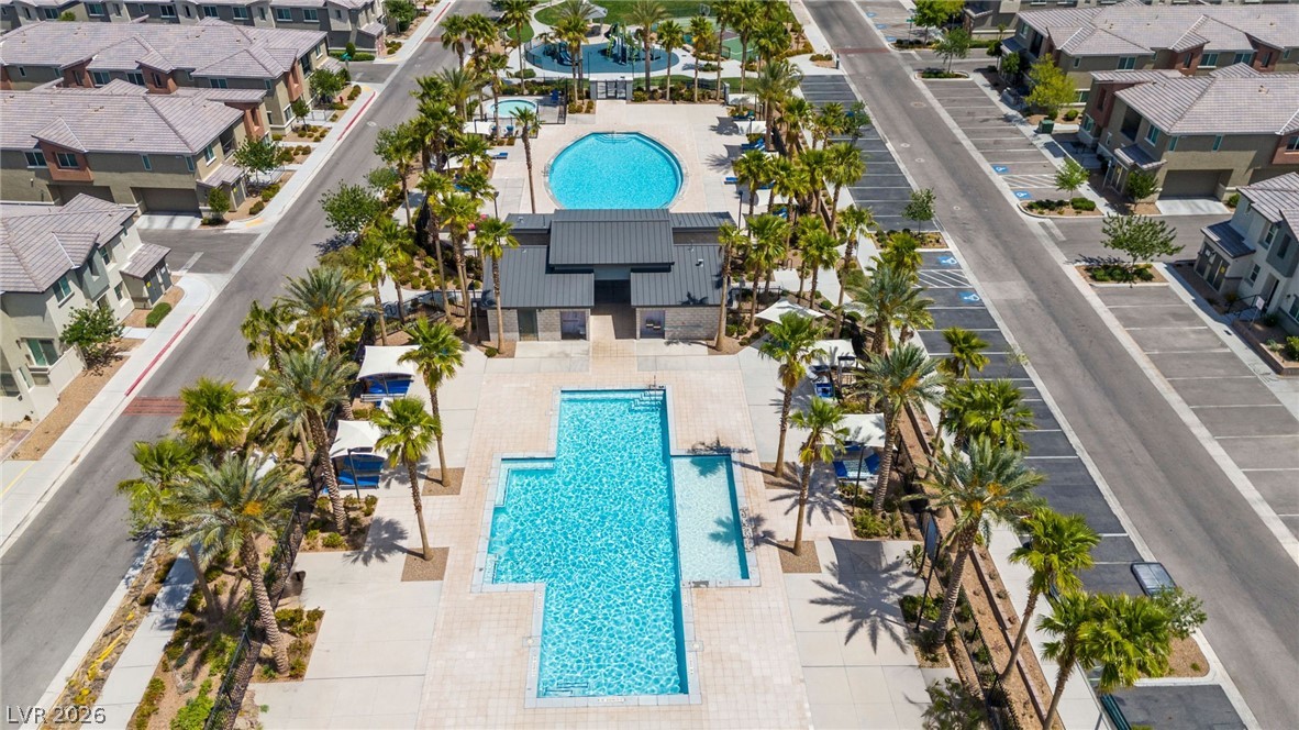 12367 Indigo Montage Road, Unit 3 Las Vegas, NV 89183 - Photo 27 of 33 An aerial perspective reveals a vibrant community with inviting pools and abundant palm trees.