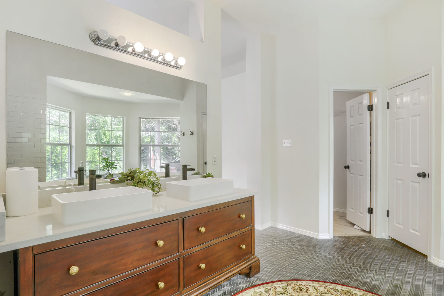 206 Gann Street Georgetown, TX 78626 - Photo 11 of 19 a spacious bathroom with a granite countertop sink a mirror and a shower