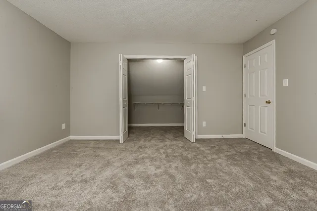 an empty room with closet area